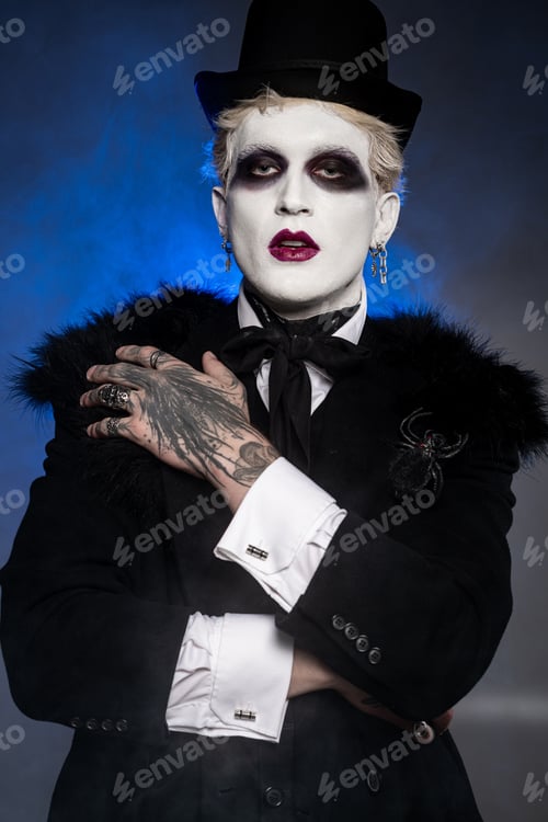 Preview: Young handsome man dons an epic Halloween costume with striking makeup and stylish accessories