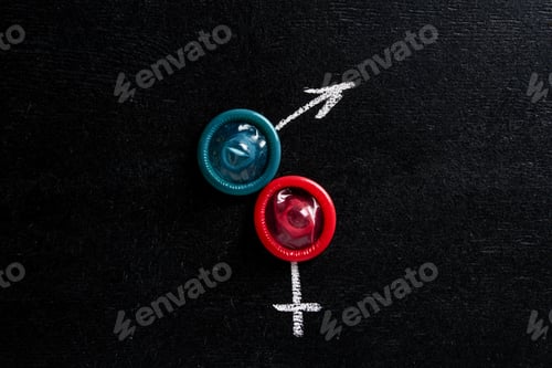 Preview: top view of condoms with male and female signs on black background