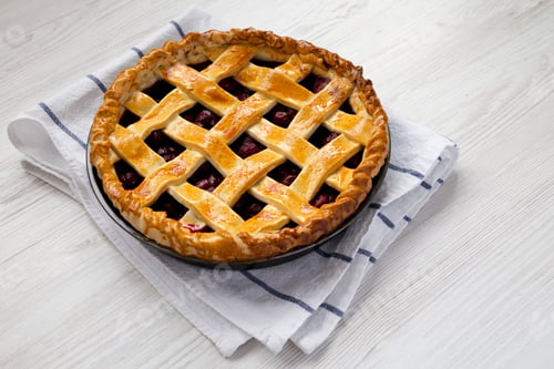 Preview: Yummy Homemade Cherry Pie on a white wooden table, side view. Space for text.