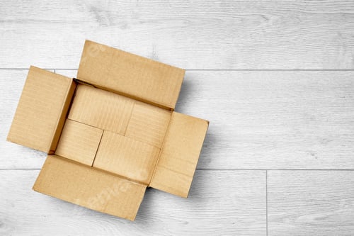 Preview: Open empty cardboard box on wooden floor