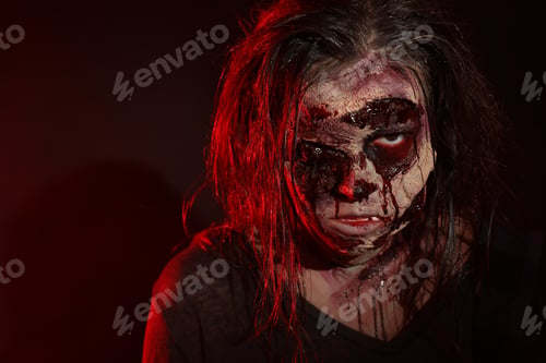 Preview: Scary zombie on dark background, closeup. Halloween monster