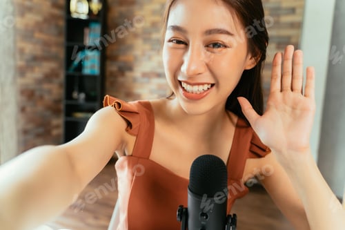 Preview: Cheerful blogger using mic for podcast