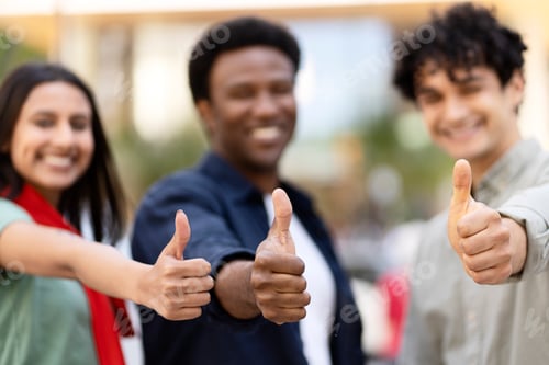 Preview: Diverse young people showing thumbs up gesture
