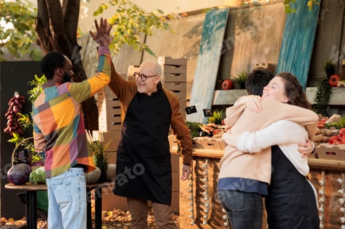 Preview: Cheerful local vendor greeting customers with highfive and hug