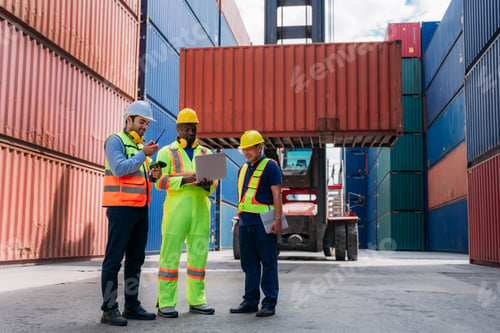 Preview: Industrial Engineer checking inventory or task details at Container cargo harbor.