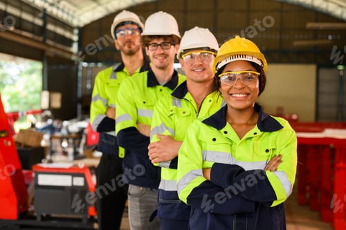 Preview: Group of technicians engineers workers posing to camera with smile