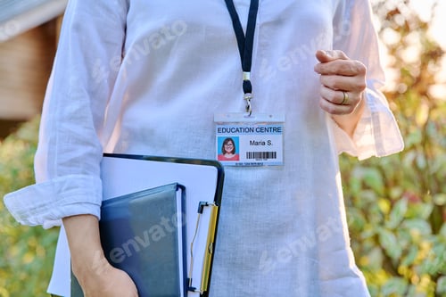 Preview: Close-up of badge on woman worker of educational center