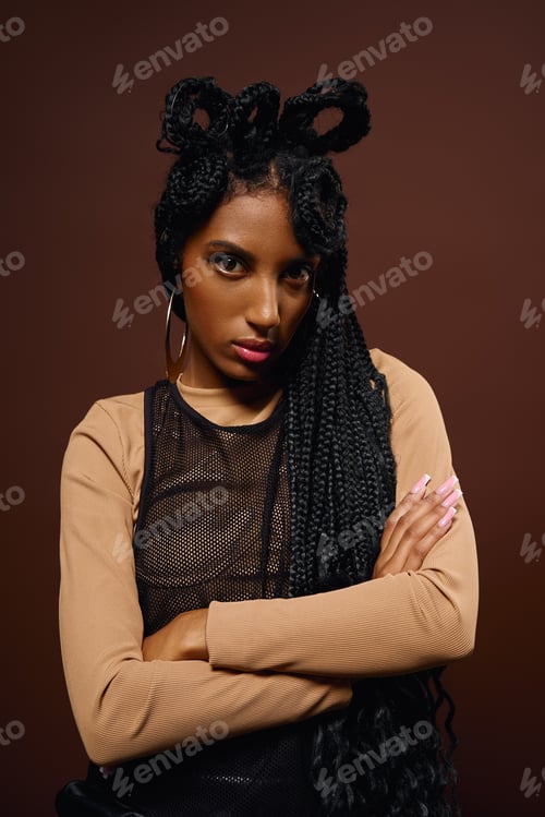 Preview: A young woman flaunts her stylish outfit and intricate braids, radiating confidence.