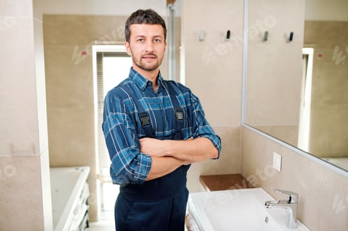 Confident Plumber Standing in a Brightly Lit Bathroom