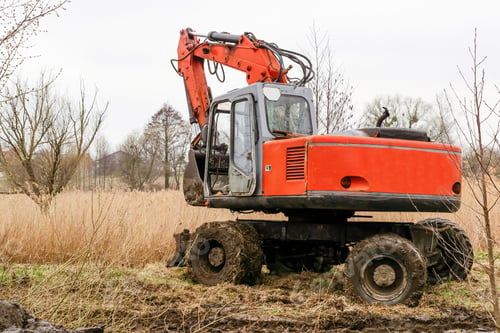 Preview: Modern red tractor machinery plowing agricultural field meadow at farm at spring autumn.