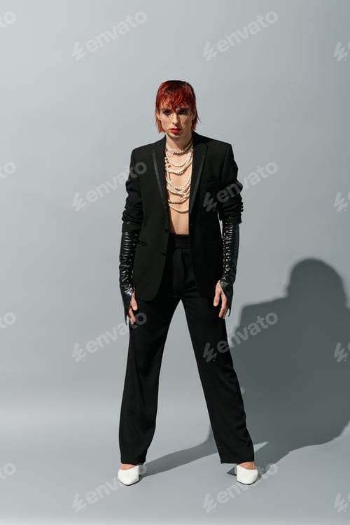 Preview: A unique young man showcases a daring outfit with flair, exuding confidence in a striking pose.