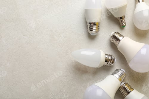 Preview: Energy saving bulbs on white textured background