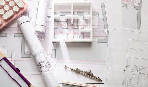 Preview: Construction concept. Residential building blueprint drawings and a pink computer keyboard