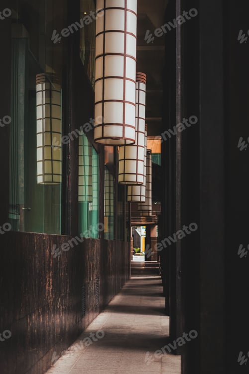 Preview: Urban alleyway with hanging lanterns casting shadows.