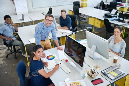Preview: High angle portrait of a group of designers working at their computers in an office
