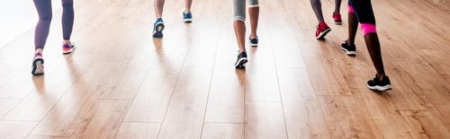 Preview: Cropped view of multicultural dancers performing zumba in dance studio, panoramic shot