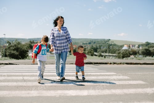 Preview: Mother and her children crossing a road on way to school in the morning