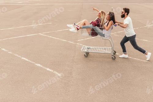 Preview: Young hipsters having fun on parking lot