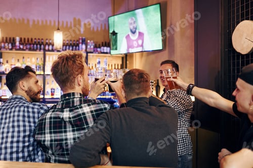 Preview: Group of people together indoors in the pub have fun at weekend time