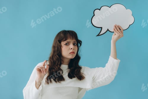Preview: Woman Holding a Speech Bubble Sign Against a Blue Background