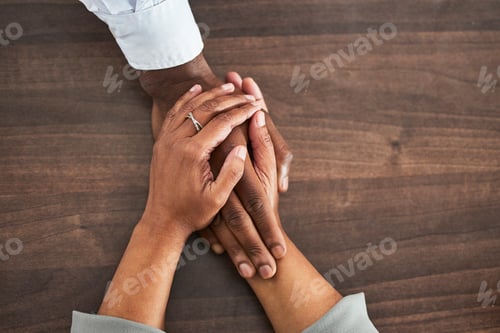 Preview: Holding hands, support and trust with people, help and closeup on wood table with communication and