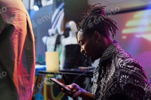 Preview: Man using smartphone in nightclub
