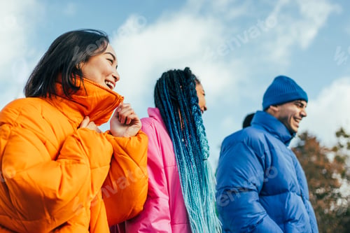 Preview: Multiracial group of young friends meeting outdoors in winter