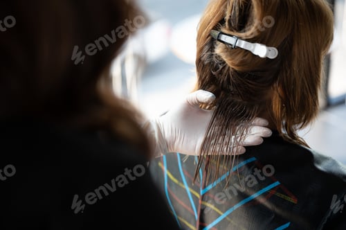 Preview: woman client person having a process to making treatment a hair with hairdresser in beauty salon