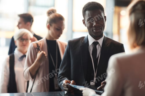 Preview: Businessman registering at conference