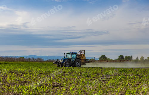 Preview: Agricultural tractor spraying field