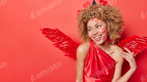 Preview: Cheerful glad woman with kiss traces on face dressed like cupid helps people to match and find your