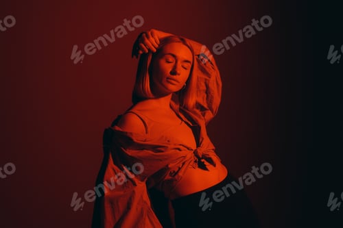 Preview: Serene female model in dark studio