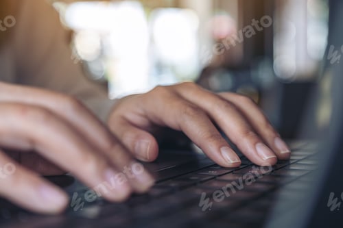 Preview: Closeup image of hands using and typing on laptop keyboard