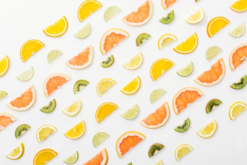 Preview: Flat lay with juicy cut fruits on white surface