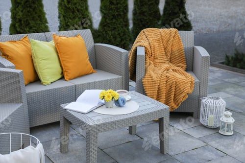 Preview: Beautiful rattan garden furniture, soft pillows and different decor elements outdoors