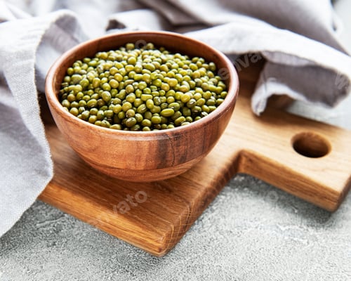 Green Mung Beans in Wooden Bowl on Board