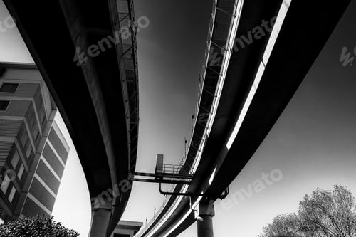 Preview: Low angle greyscale of a concrete bridge under the sunlight at daytime