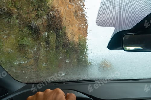 Preview: Water on top of the car driving inside a car at Anjos Waterfall, Madeira. Portugal