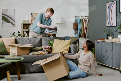 Preview: Multiethnic Couple Packing Clothes for Home Move and Relocation