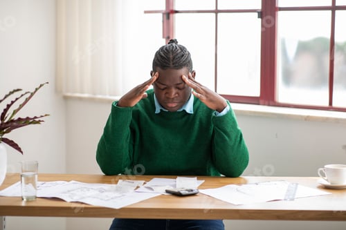 Preview: Desperate Black Businessman Having Financial Difficulties Calculating Expenses In Office