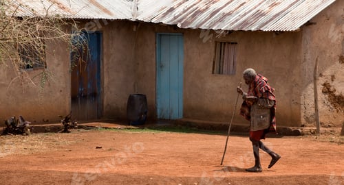 Preview: Senior woman walking through village, Tanzania, Africa