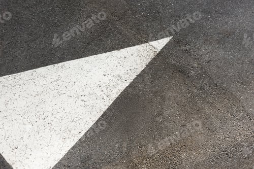 Preview: White painted arrow on asphalt road