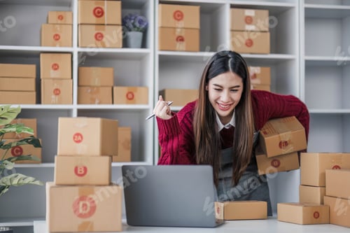 Preview: Startup small business entrepreneur SME, asian woman packing cloth in box. Portrait young Asian