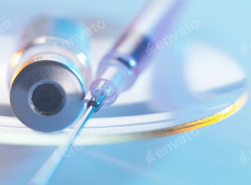 Preview: Vaccine and hypodermic syringe sitting on a glass dish