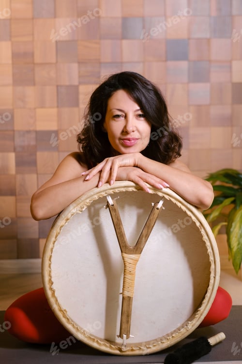 Preview: Portrait of an athletic woman with a tambourine in the gym. Kalimeditation class