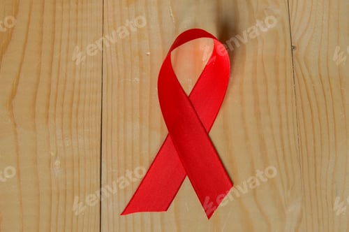Preview: Awareness red ribbon on wood background: world day fight against AIDS, promotions to public support