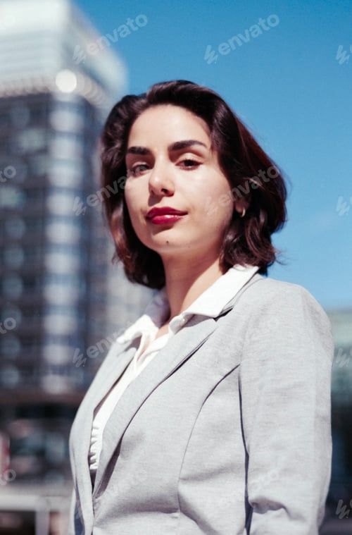 Preview: Confident businesswoman posing outdoors in city environment