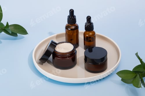 Preview: Beauty cosmetic skincare products on ceramic tray on blue background, set of jars, droppers a