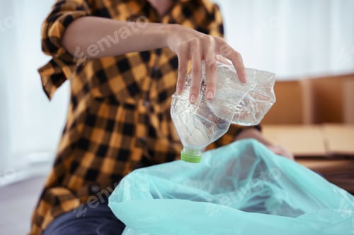 Preview: Women squeeze plastic bottle and putting in plastic bag for recycling and conservation environment