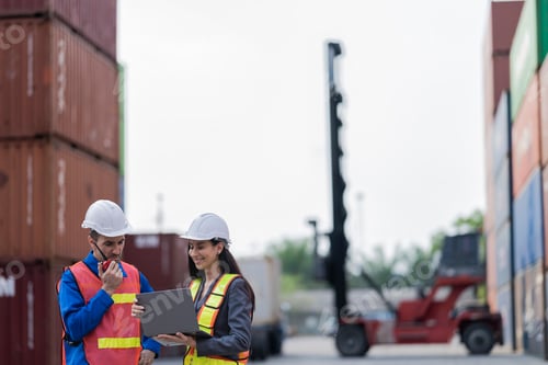 Preview: workers in high visibility safety gear and hard hats discuss operations
